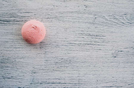 pink marshmallows on a light wooden backgroundの写真素材