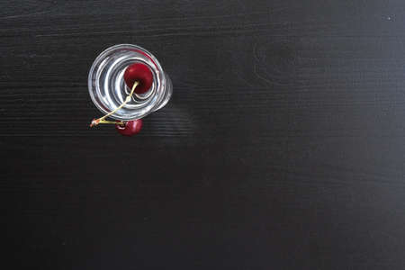 cherries in a stack of water on a dark background