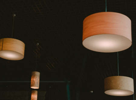 orange round chandeliers under the ceiling in a room or cafeの写真素材