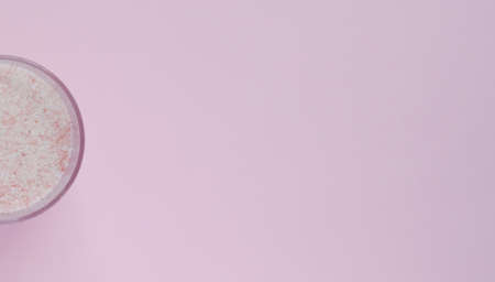 finely ground pink salt on a pink backgroundの写真素材