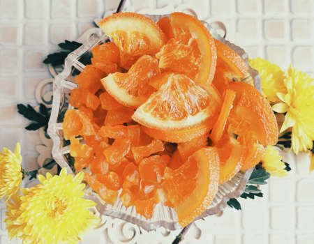 candied orange slices, fruit decor and yellow chrysanthemumsの写真素材