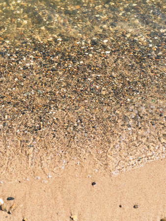 surf on the beach, sandy beach with pebblesの写真素材