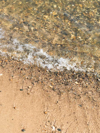 surf on the beach, sandy beach with pebblesの写真素材