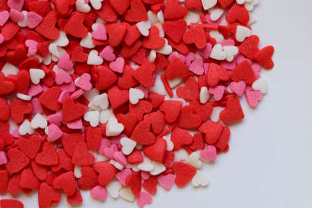 sprinkle hearts on a white background with a place for textの写真素材