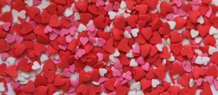 sprinkle hearts on a white background with a place for textの写真素材