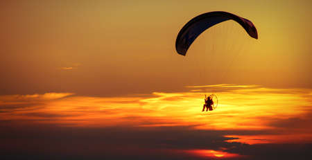 man enjoying paraglider on skyの写真素材