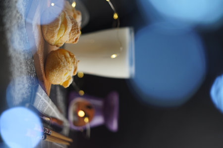 Selective focus of cream puff and milk on the table with a light bokeh effect.