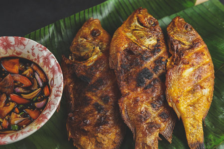 close up view grilled fish with sauce concept asian food.の写真素材