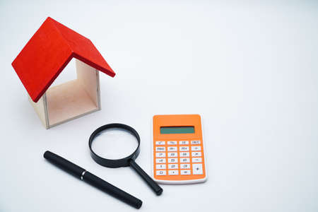 calculator, money and house with white background. copy space textの写真素材