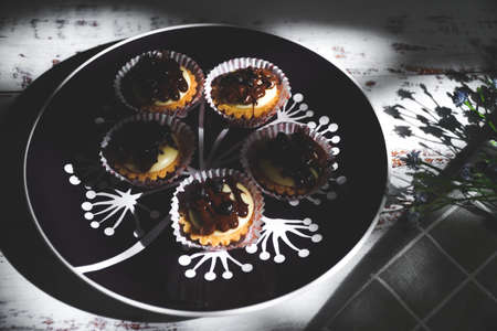selective focus of cheese tart on the table with a cinematic light.