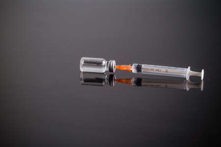Close up Vaccines and syringe on the tableの写真素材