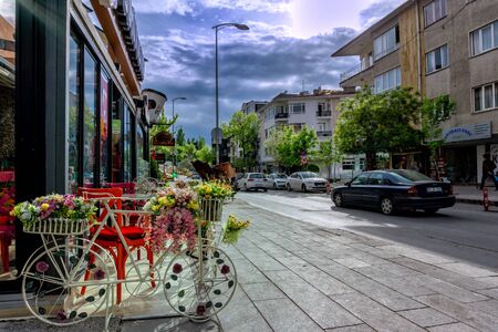 decoratve bicycly with flowers on a street in from of a cafe or storeのeditorial素材
