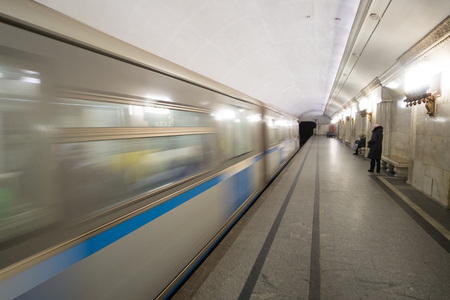 Subway cars speed by in blurred motion in the Moscow metro station.の写真素材