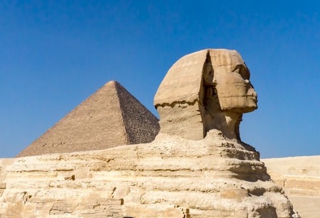 Sphinx in Giza, Egypt with pyriamid in the background on a clear, sunny dayの写真素材
