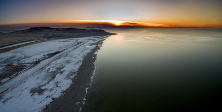 Aerial view of a shore or seascape along a coastline during a golden sunsetの写真素材