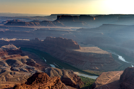 Beautiful geological formations on a hazy, summer day and the river bend in the high, desert countryの写真素材