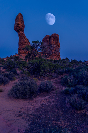 The half-moon over the stone monument on a clear night in the desertの写真素材