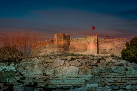 Midieval crusader castle flying a Turkish flag at sunsetの写真素材