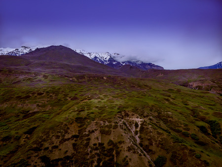 beautiful view of the foothills and snowcapped rocky mountains with clouds and a blue skyの写真素材