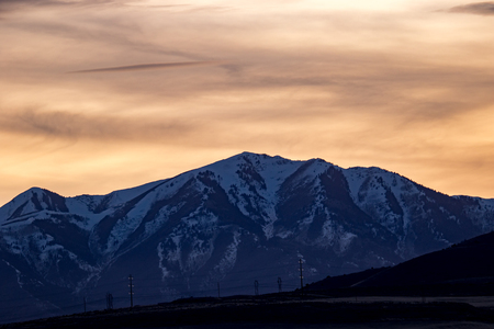 Snowy ridgeline in the Rocky Mountains at sunset or sunriseの写真素材