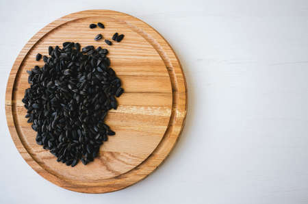 Sunflower seeds on bright wood background