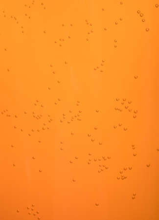 Small bubbles on orange background.の写真素材