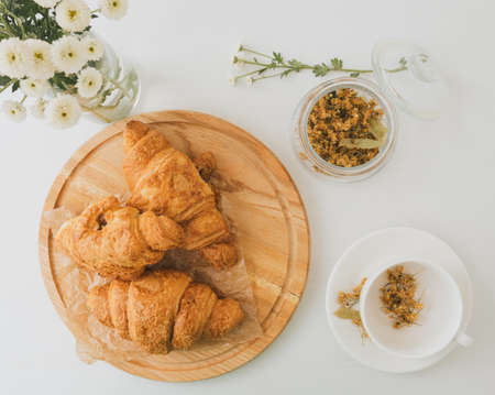 Top view of tasty croissants on wooden plate.の写真素材