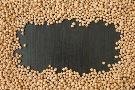 Frame made of fresh chickpea on black background.の写真素材