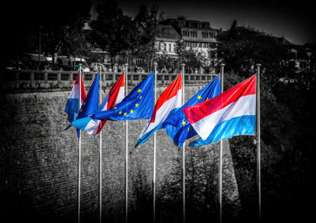 Waving flags of Luxembourg and the European Union in the city of Lucembourg in autumnの写真素材