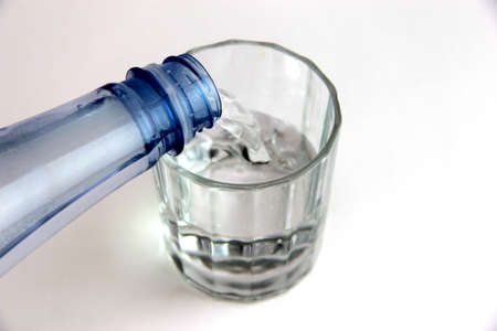 glass of water with plastic bottleの写真素材