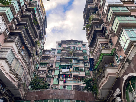View of crowded residential apartment buildings with balconies and air conditioners in Guangzhou...