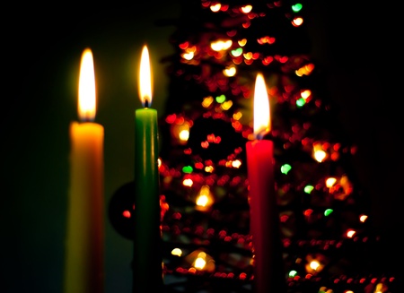 three candles on the black background with heartsの写真素材