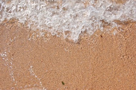 Breaking about sand's  coast of Black sea a small wave
