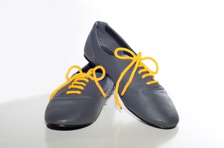 gray boots with yellow laces on a white background