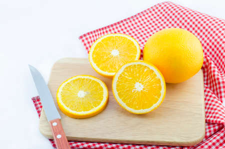 slice of orange with knife and wooden boardの写真素材
