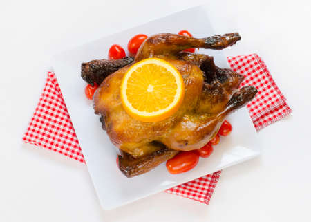 Roasted chicken and sliced orange,cherry tomatoesの写真素材