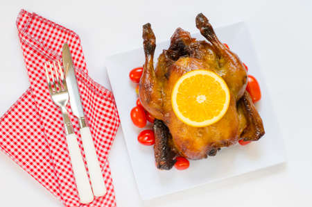 Roasted chicken and sliced orange,cherry tomatoesの写真素材