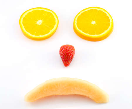 Sad face by mix fruits,orange strawberry,melonの写真素材
