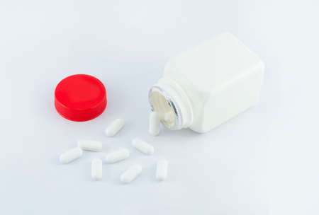 pills with bottle on white backgroundの写真素材