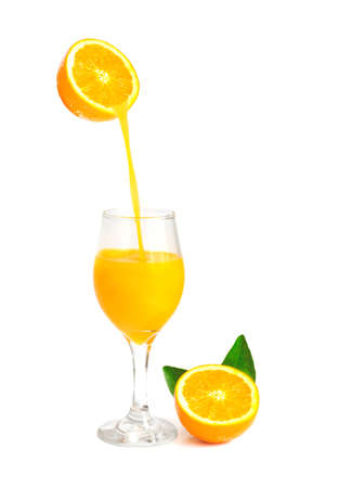 orange juice pouring into glass with orange slice and leaf isolate on white with work pathの写真素材