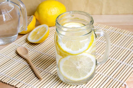 Soda with lemon in jar on wooden tableの写真素材