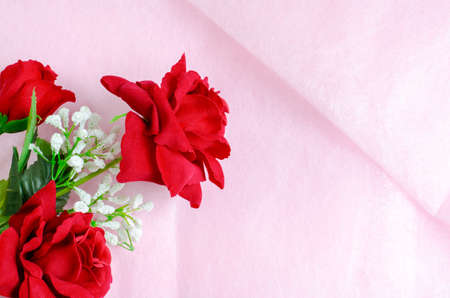 Artificial rose bouquet on pink backgroundの写真素材