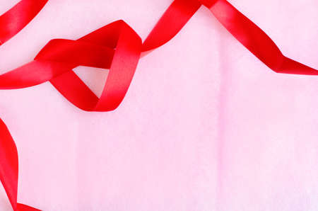 Rosy pink paper texture background with red ribbonの写真素材