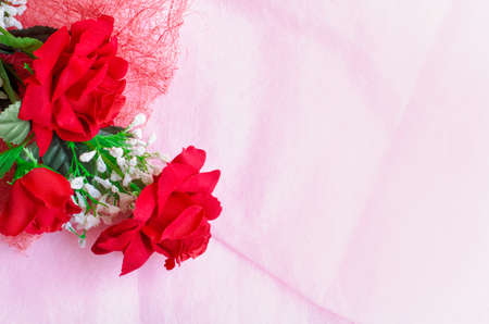 Artificial rose bouquet on pink backgroundの写真素材