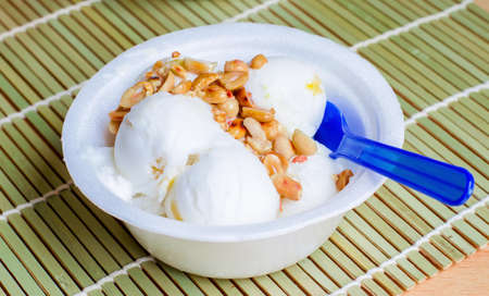 Coconut ice cream homemade with roasted peanutsの写真素材