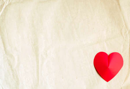 Heart shape on old paper backgroundの写真素材