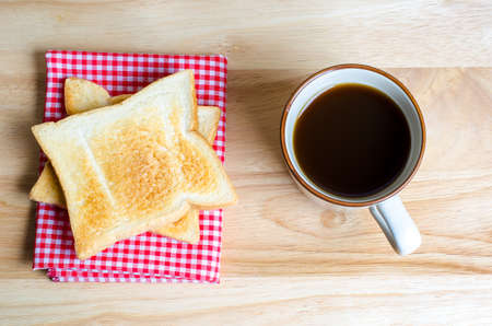 Coffee and toasts on wooden tableの写真素材