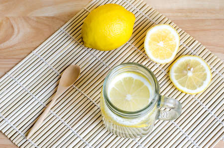 Soda with lemon in jar on wooden tableの写真素材