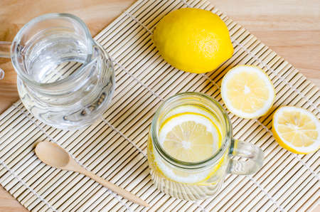 Soda with lemon in jar on wooden tableの写真素材