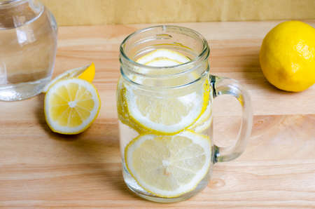 Soda with lemon in jar on wooden tableの写真素材